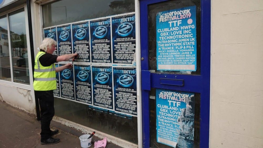 removing flyposting (image courtesy Carluke BID)