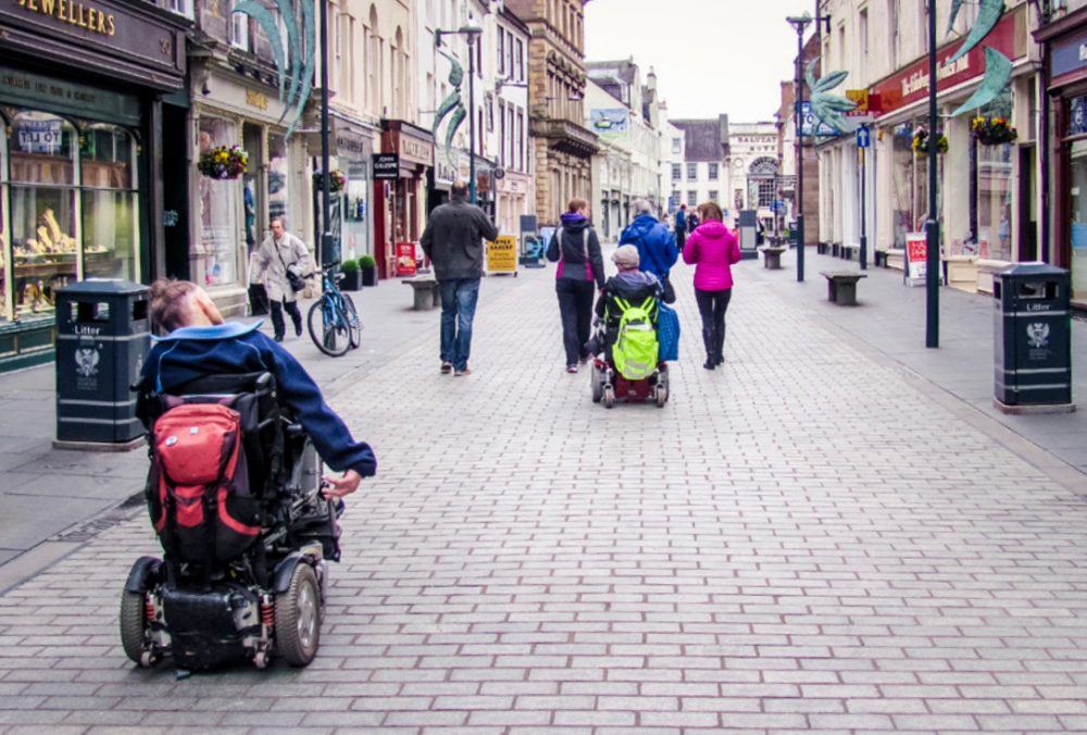 wheelchairs users and pedestrians in a town centre